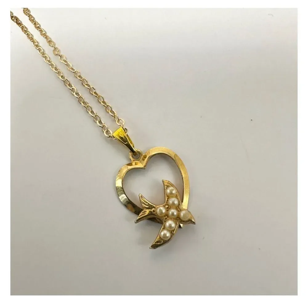 Gold tone heart with faux pearl bird pendant necklace